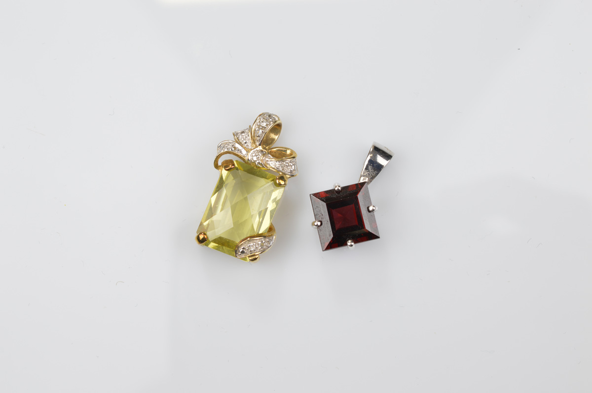 Two certificated 9ct gold gem set pendants, comprising a rhodolite garnet, the mixed square cut in