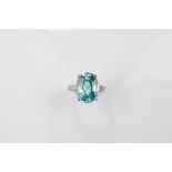 A certificated 9ct gold zircon and white topaz dress ring, the oval mixed cut blue zircon with white