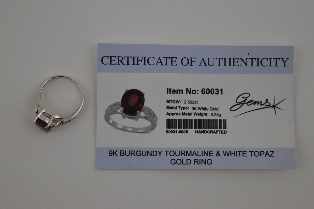 A certificated 9ct gold tourmaline and white topaz dress ring, the oval burgundy coloured mixed - Image 2 of 2