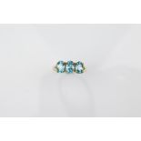 A certificated 9ct gold three stone blue zircon dress ring, the oval mixed cuts in claw settings all
