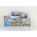 Four boxed Lego City models, including Prisoner Transport 7286 opened with manual and unchecked,