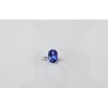 An 18ct gold tanzanite dress ring, oval mixed cut tanzanite in four claw setting, ring size M,