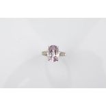 A certificated 9ct gold Brazilian kunzite and diamond white gold dress ring, the oval mixed cut claw