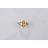 A certificated 18ct gold yellow beryl and diamond dress ring, the marquise cut yellow beryl with