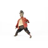 A Tinplate Clockwork Figure Of A Man On Skis, possibly Günthermann, remains of painted facial