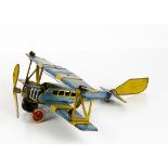 A Distler Tinplate Clockwork Bi-Plane, blue and yellow body with two pilots, 'JD 2755' markings to