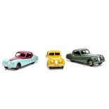 Dinky Toys 157 Jaguar XK120, three examples, first sage green body, fawn hubs, second yellow body,
