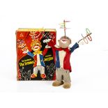 A German 1950s/60s 'The Famous Juggler' Clockwork Clown Toy, plastic bodied clown figure with