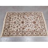A Kamali traditional style cross woven woollen rug, with floral decoration on a cream coloured
