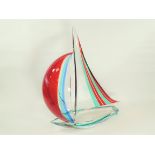 An Italian Murano glass sculpture of a sailing boat, with encased red, blue and green colouration,
