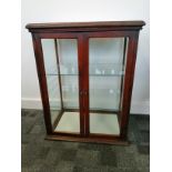 A late 19th or early 20th Century mahogany framed glass shop display cabinet with lettering to two