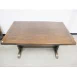 A Ercol style drawer leaf table, mahogany top, stained beech base with shaped end supports united by