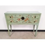 A painted softwood narrow side cabinet, with floral decoration on a turquoise ground, central double
