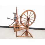 Oak spinning wheel, with turned spindles, legs and supports. 90cm W x 45cm L x 94cm H (56cm diameter