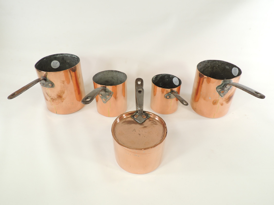 Five late 19th or early 20th Century copper saucepans in various sizes, one with visible Benham &