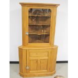 An Alan Solly contemporary two section oak corner cupboard, the upper section having a moulded