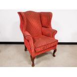 Victorian wing back arm chair, upholstered in a red stripe fabric with mahogany feet in Queen Anne