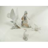 Four Spanish Lladro porcelain figures with a theme of birds, a girl and boy approaching a goose, two
