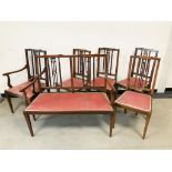 An Edwardian mahogany inlaid saloon suite, with inlaid banding and walnut panel, comprising two seat