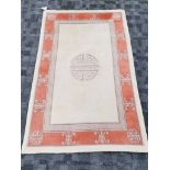 A Peking Oriental rug with central shou symbol, on a cream ground with a key fret border, 187cm x