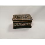 A 19th Century black lacquered tea caddy raised on four bun feet, with inset mother of pearl