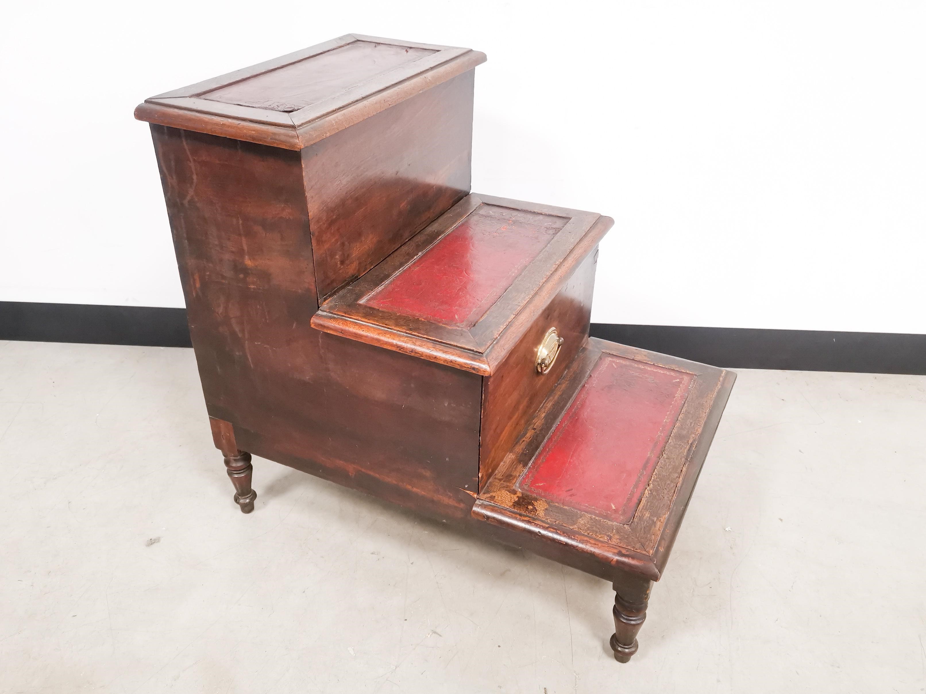 Mahogany leather topped library step, with central pull out storage compartment.