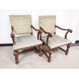 A pair of 'Boet' oak framed lounge chairs, with scroll arms, green upholstery (faded). Floor to