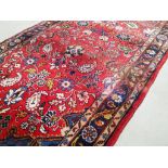 Woollen floral and paisley patterned runner, on a light red ground, 77cm x 300cm