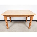 Modern pine dining table, on turned legs. 122cm W x 76cm D x 77cm H