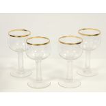 Four German glasses with engraved interlaced decoration surmounted by crowns, raised on multifaceted