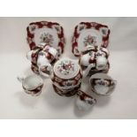 A Royal Standards English bone china tea set for ten in the 'Lady Jane' pattern, with crimson