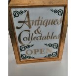 An illuminated lightbox sign 'Antiques and Collectables Open', this point of sale sign for the