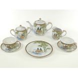 A Japanese porcelain tea set for six by the Kutani china factory, with typical landscapes and the