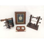 Two 20th Century oak spinning reels, together with a barometer and novelty framed quartz clock,