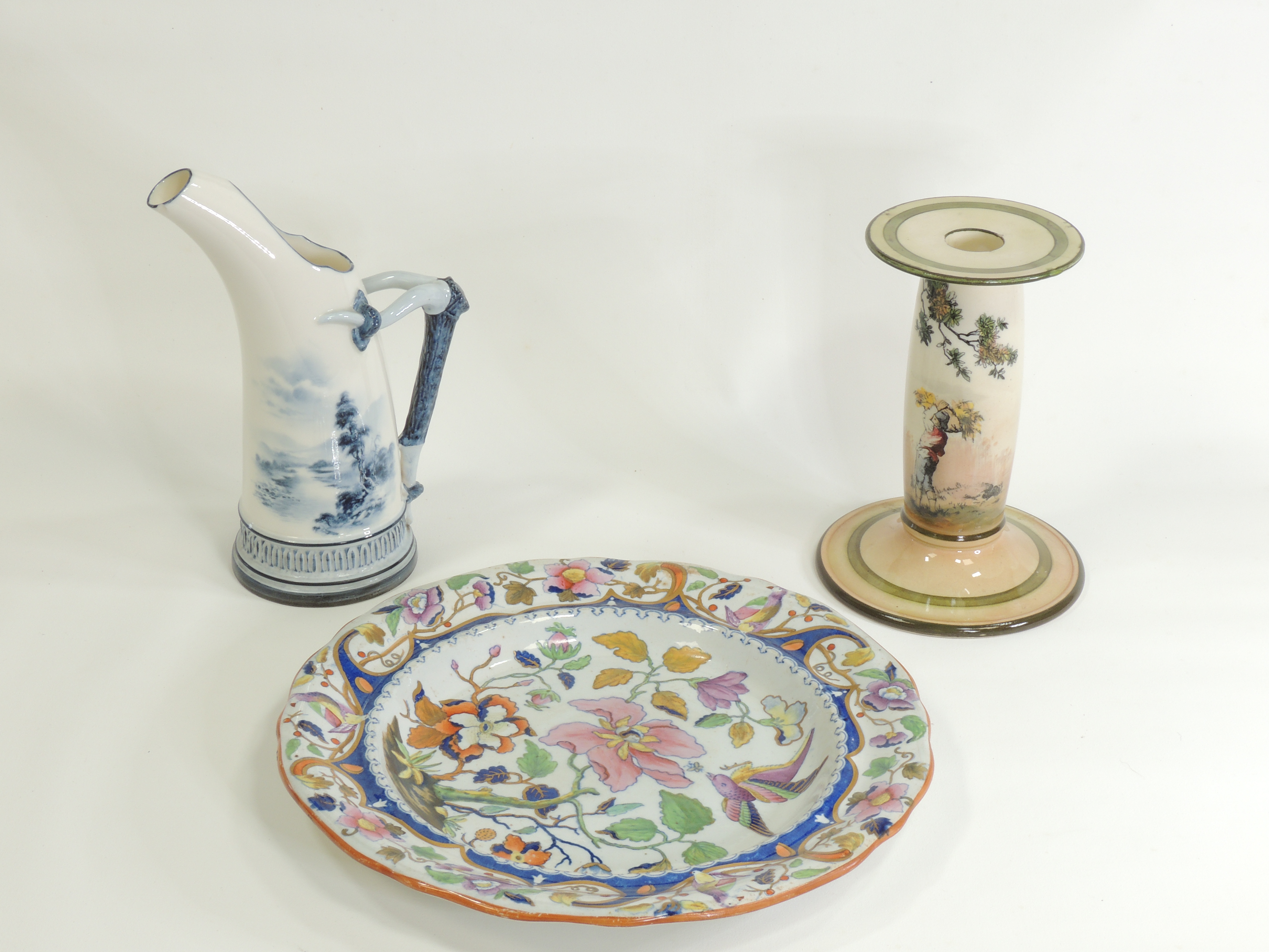 A Royal Worcester ewer with naturalistic handle and hand painted landscape, the base with factory