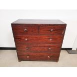 Early 20th Century pine two over three chest of drawers, with dark stain, set on small bun feet.