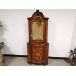 A mahogany marquetry corner cabinet, heavily detailed in a Dutch style, with single glazed door