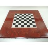 A 20th Century limestone table top chess board, with felt base, the black and white chequered