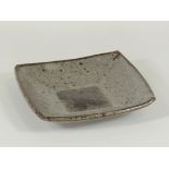 Janet Leach (1918-1997) a square stoneware bowl, with ash glazed interior and bisque base with
