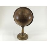 A Victorian terrestrial globe dating between 1840 and 1852, with brass bracket and stand,