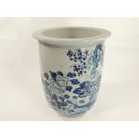 A provincial style underglaze blue and white Chinese jardinière, with a depiction of plum blossom