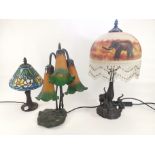 A group of three 20th Century decorative table top lamps, one in the style of Tiffany with a stained