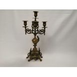 A late 19th or early 20th Century brass four branch freestanding table top candelabra, raised on a