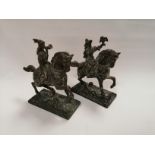 A pair of 20th Century cast metal figures on horseback, both in Medieval dress, one with trumpet the