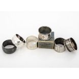 Four Edwardian and later silver napkin rings, one heavy example with engraved inscription for HMS