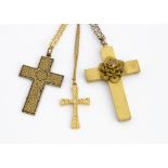A Damascene style cross pendant, the oxidised metal with an all over floral gilt painted