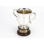 A George V silver twin handled trophy cup by William Hutton & Sons, dented to base, with later