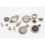 A collection of gold and silver charms, including a silver and 9ct gold Maltese Cross medallion, a