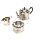 A Victorian silver three piece bachelors tea set by EF HT, the teapot with wooden finial and handle,
