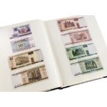 A folder containing European and Asian bank notes, with examples from Bulgaria, Ukraine, Moldova,